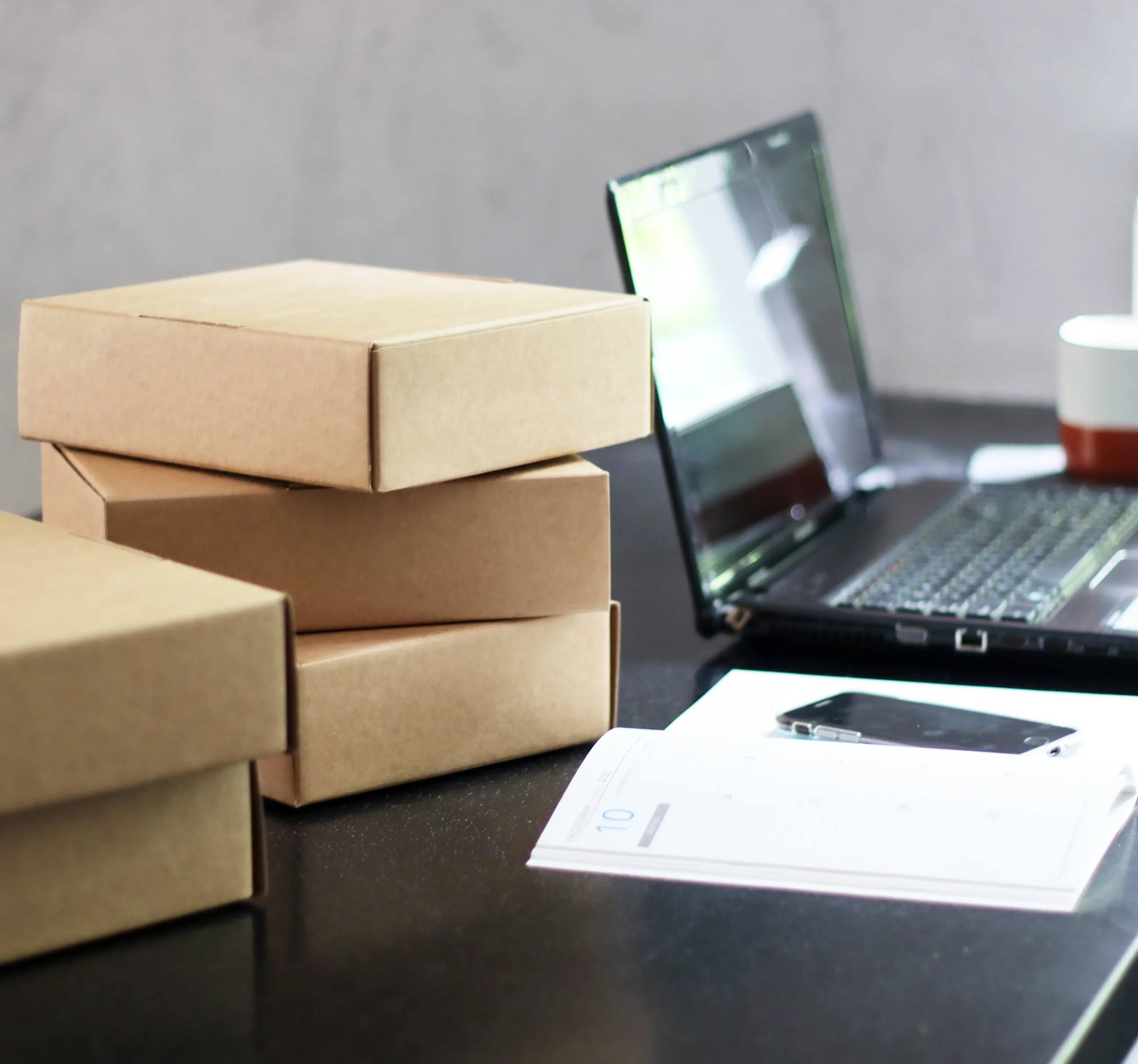 boxes-calendar-laptop-and-mug-on-a-desk-2026-03-20-00-54-32-utc (1)